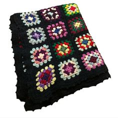 a crocheted blanket with flowers and hearts on the edges is shown in multicolors