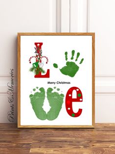 a christmas print with the letter e and handprints for baby's feet