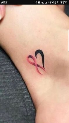 a woman's foot with a tattoo that has an omen symbol on it