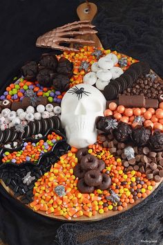 a decorated halloween platter with chocolate, candy, and candies on it's side