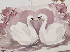 two white swans with their heads in the shape of a heart, sitting next to each other