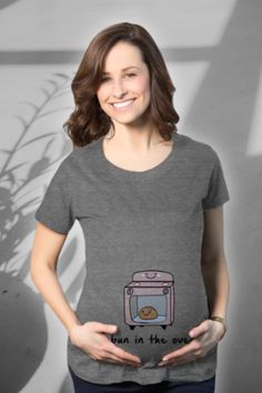 Celebrate the sweet expectation with our 'Bun in the Oven' maternity t-shirt! This funny shirt features a playful visual pun, making your pregnancy journey even more delightful. Crafted from super soft, high-quality ringspun cotton, it ensures lasting comfort beyond your baby bump's journey. With ruched sides and available in five sizes, fitting comfortably into this beauty is a breeze. Share the joy of your little bun with the world – order this maternity tee today! 🍞🤰 #MaternityFashion Happy Camper Tshirt, Camper Tshirt, Fall Shirts Women, Bun In The Oven, Western Graphic Tees, Maternity Shirt