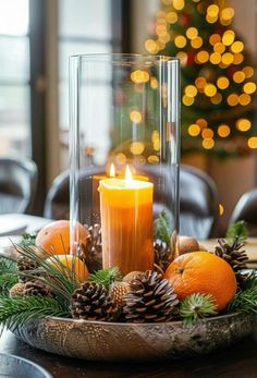 a candle and some pine cones on a table