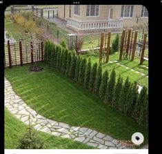 an aerial view of a garden with green grass and stone paths leading up to the building