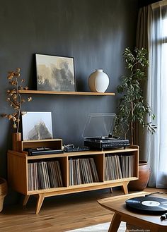 a record player is sitting on top of a shelf in front of a large window