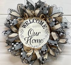 a welcome to our home wreath hanging on the wall