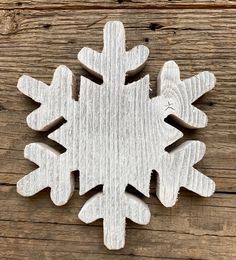 a wooden snowflake sitting on top of a wooden table