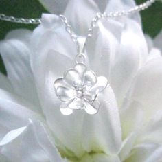 Item details: This very beautiful double layer 10 pedal flower charm is .925 sterling silver. It is hung from a very nice solid sterling silver chain. This beautiful necklace will go with any outfit.   About this necklace: *Solid sterling silver chain and components  *Sterling silver flower charm is 5/8" high and 1/2" wide. *Comes beautifully package & ready for gift giving Shipping: All items purchased from the shop are sent out with priority shipping! I will get items out between 3 to 5 business days after payment. Domestic orders are sent via USPS First Class Mail and generally take 2-5 business days to arrive. However, packages can take longer to arrive do to holidays and unforeseen events, though this is very rare. Exceptions are explicitly stated in the items' description. Missing Pa Sterling Silver Birth Flower Necklace For Wedding, Silver Flower Necklace For Anniversary, Delicate Silver Flower Charm Necklace, Silver Delicate Flower Charm Necklace, Dainty Silver Flower Charm Necklace, Silver Necklace With Flower Charm For Anniversary, Nickel-free Sterling Silver Flower Necklace, Sterling Silver White Gold Flower Necklace, White Gold Sterling Silver Flower Necklace