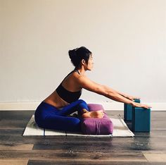 a woman is doing yoga on a mat