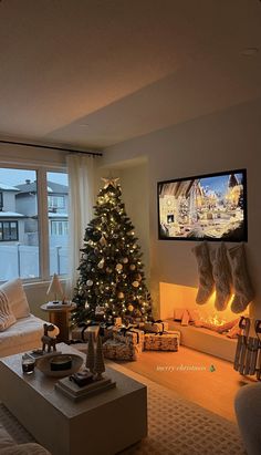 a living room filled with furniture and a christmas tree in front of a flat screen tv