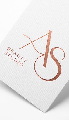 the logo for beauty studio is shown on top of a white card with copper foil