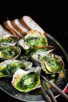 an image of oysters with pesto sauce on them