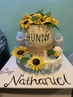 a cake made to look like a barrel with sunflowers on top and the words hummy written in black