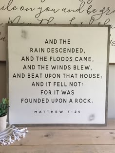 a wooden sign that says and the rain descended, and the floods came, and the winds blew, and beat upon that house and it felt not for it was found upon a rock