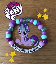 the pony bracelet is purple and blue with stars around it, which says little pony starlight