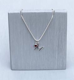 Set on an 18inch sterling silver chain is a sterling silver initial letter M and a Garnet birthstone charm. Presented in a gorgeous cream magnetic jewellery box. All birthstone colours are available please choose on check out  All letters are available please view my other listings or contact me if you cannot find the letter you are looking for