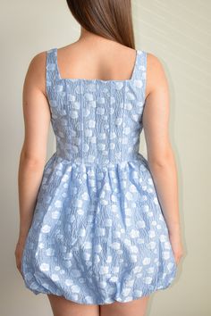 Elevate your style with our Sky Blue Flower Corset Mini Dress. This stunning mini dress is designed to make a statement. Crafted from monochromatic crepe fabric, the corset-style top features a square neckline, fixed tank straps, and eye-catching little flower applied that add a touch of elegance and charm to your look. Below the corset, the mini A-line skirt is gathered at the hem and fastens with an invisible back zipper, ensuring a secure and stylish fit. Made from a blend of 80% Acrylic and Fitted Blue Corset Dress For Spring, Blue Sleeveless Mini Dress With Corset Back, Blue Mini Dress With Straight Neckline, Summer Mini Dress With Square Neck And Lined Bodice, Blue Dress With Fitted Bodice And Square Neck, Blue Square Neck Dress With Fitted Bodice, Blue Corset Dress With Sweetheart Neckline For Spring, Fitted Blue Corset Dress For Summer, Blue Fitted Corset Dress For Summer