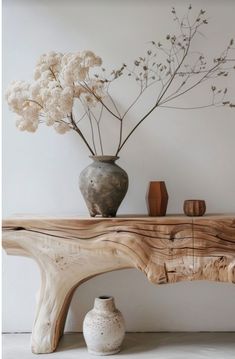 a wooden table with vases and flowers on it