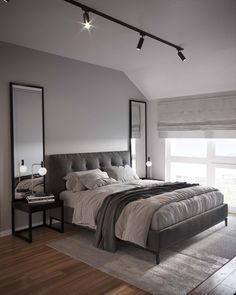 a bedroom with a large bed and two mirrors on the wall