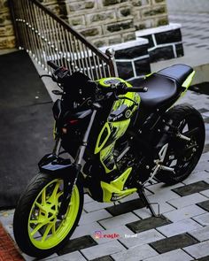 a black and yellow motorcycle parked on the street