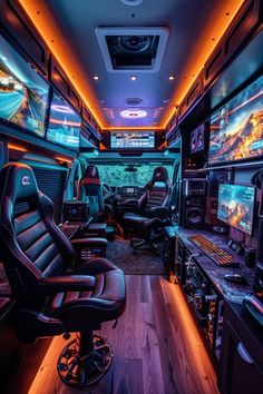 the interior of a vehicle with many monitors and video game equipment on it's walls