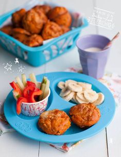 a blue plate topped with meatballs and veggies next to a cup of milk