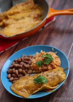 an omelet and beans are on a blue plate