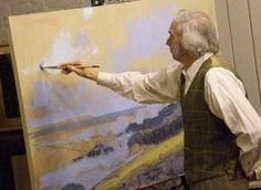 an older man is painting on the easel