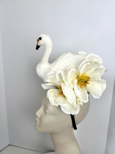 "Ivory Bird Fascinator- Feather Headband- Swan Lake- Kentucky Derby- Feather Headband Hello,            This fascinator is perfect to add whimsical fun to any occasion. You'll be the life of the party with this great conversation piece This MEDIUM SWAN feather and magnolia fascinator has a white swan that is about 7\" high sitting in a bed of magnolias.  It's not a real bird, it's Styrofoam covered with feathers and is very light. The off white magnolias are about 6\", and have a yellow center. White Hair Accessories For Kentucky Derby, White Whimsical Headband Fascinator, White Headband For Royal Ascot, White Formal Headband For Royal Ascot, Whimsical White Fascinator For Royal Ascot, White Headband For Kentucky Derby, Whimsical White Fascinator For Kentucky Derby, White Headband For Royal Ascot Races, Whimsical White Headband For Spring