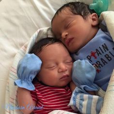 two babies are sleeping together in a crib