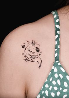 a woman with a tattoo on her shoulder