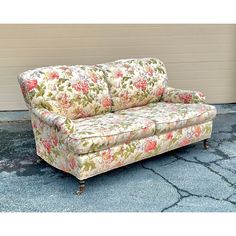 a floral couch sitting in front of a building