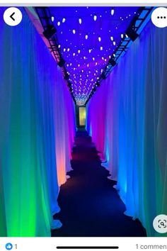 an image of a long hallway with lights on the ceiling and drapes covering it