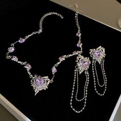 Purple Heart Jewelry Set - Regal Elegance 💜💎 💜 Heartfelt Splendor: The Purple Heart Jewelry Set is a regal ensemble featuring heart-shaped jewels in a rich shade of purple. It exudes an air of sophistication and timeless elegance, making it a perfect choice for those who appreciate the enduring allure of hearts. 💎 Elegant Charm: This set adds a touch of graceful charm to any outfit, whether it's for a formal event or a casual day out. Let it be a symbol of your refined taste and style, eleva Purple Heart Necklace, Heart Jewelry Set, Y2k Jewelry, Necklace And Earrings Set, Set Necklace, Chains Necklaces, Purple Heart, Necklace And Earrings, Heart Jewelry