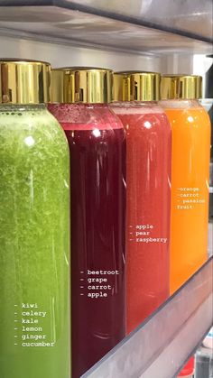 the bottles are labeled with different types of juices in them and on display for sale