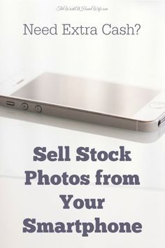 a cell phone sitting on top of a table next to a white sign that says sell stock photos from your smartphone