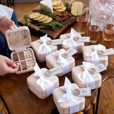 a table topped with lots of jewelry boxes filled with rings and earrings on top of it