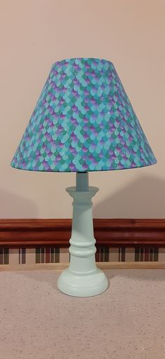 a blue lamp sitting on top of a table