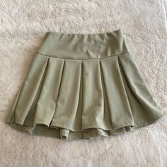 Brand New With Tags Never Worn. Short Tennis Skirt, No Shorts Attached Underneath. Thick Elastic Waistband. 96% Polyester. 4% Spandex. Size Small Spring High-waisted Tennis Skirt, Solid High-waist Tennis Skirt For Spring, Solid Pleated Mini Skirt For Day Out, Solid Color Mini Pleated Skirt For Day Out, Mini Length Pleated Skirt For Day Out, High Waist Solid Color Tennis Skirt For Spring, High-waisted Khaki Skort For Spring, Casual High Waist Solid Color Tennis Skirt, Trendy Khaki Skort For Spring