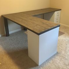 an office desk with two file cabinets in the corner and carpet on the floor next to it