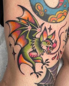 a woman with a dragon tattoo on her thigh