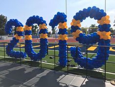 some blue and yellow balloons are in the shape of letters