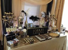 a table topped with lots of desserts next to a window filled with curtains and drapes