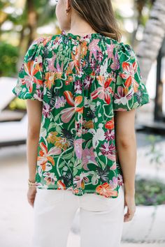 We hope you have all the plans for this blouse! It's sure to take you from the office to the beach side restaurant! That tropical floral print is so fun and colorful! Round neckline Smocked yoke Button keyhole back Short bubble sleeves Tropical floral print No stretch Savannah is wearing the small. Green Hawaiian Top For Spring, Spring Hawaiian Green Top, Hawaiian Printed Top For Day Out, Vacation Tops With Smocked Bodice And Short Sleeves, Summer Vacation Green Blouse, Green Summer Blouse For Vacation, Tropical Floral Print Blouse For Beach, Multicolor Tops For Brunch During Beach Season, Casual Floral Print Smocked Top For Beach