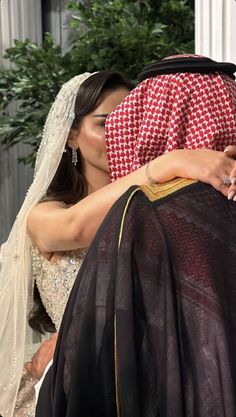 a bride and groom kissing each other on their wedding day in front of the white house