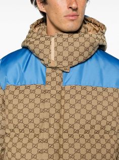 GG canvas padded down jacket from Gucci featuring sand beige, pacific blue, cotton blend, goose down, padded design, classic GG canvas, contrasting panel detail, funnel neck, concealed front zip fastening, long sleeves, touch-strap cuffs, detachable hood, two side zip-fastening pockets and elasticated hem. This item is in size 50 and the color is Gucci Cotton Outerwear For Fall, Designer Down Puffer Jacket, Gucci Winter Outerwear With Padded Collar, Gucci Winter Outerwear With Pockets, Beige Gucci Outerwear For Winter, Luxury Cotton Outerwear For Winter, Designer Beige Cotton Outerwear, Gucci Brown Outerwear With Pockets, Gucci Cotton Outerwear With Pockets