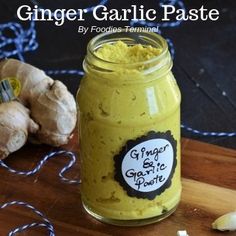 ginger garlic paste in a glass jar next to sliced ginger