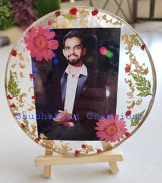 a glass plate with an image of a man in a suit and flowers on it