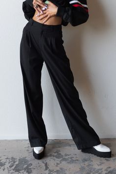 Meet your new favorite pants. Timeless and trendy are the Perfect Trouser featuring a loose fit with front pleat detail and side pockets. Color: Black Loose Fit Front Pleats Pockets Wide Leg Mid Rise Rayon Blend Model is 5'10", size 25/26 in bottoms and is wearing size small Wide Leg Dress Pants With Side Pockets For Work, Relaxed Fit Dress Pants With Side Pockets For Workwear, Classic Black Cargo Pants For Work, Baggy Wide-leg Pants For Work, Classic Wide Leg Cargo Pants For Work, Classic Wide Leg Cargo Pants For Business Casual, Classic Wide-leg Cargo Pants For Work, Chic Relaxed Fit Cargo Pants For Work, Baggy Classic Wide Leg Workwear Pants