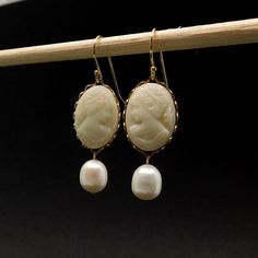 These gorgeous earrings start with off-white West German vintage glass profile cameos, placed these in gold plated lace settings. Suspended from these are plump freshwater pearls, with a great luster and minor incursions  (AAA) The earrings are 1.25 inches (3cms) in length including the quality 14kt gold-filled earwires. Any other questions feel free to contact me. To see more of my designs, including necklaces, bracelets and pearl jewelry, click on any of the links below: https://www.etsy.com/a White Pearl Earring, Vintage Cameo, Wedding Jewelry Earrings, Gorgeous Earrings, 14kt Gold, Pearl Jewelry, Pearl White, Fresh Water, Freshwater Pearls